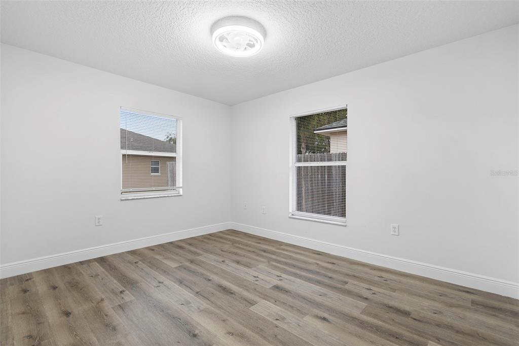 860 South Grove Street Eustis, FL 32726 - Photo 45 of 54 an empty room with wooden floor and windows