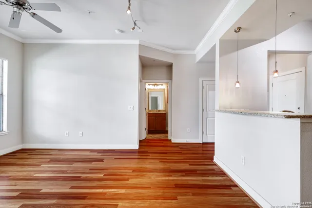 a view of a room with wooden floor