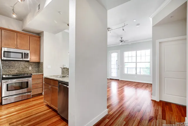 a view of a kitchen cabinets wooden floor and a window