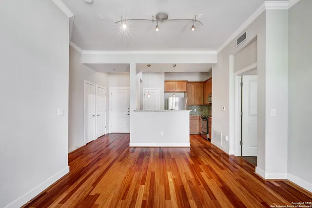 a view of a room with wooden floor and staircase