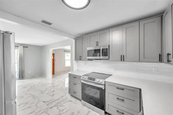 a kitchen with a sink cabinets and appliances