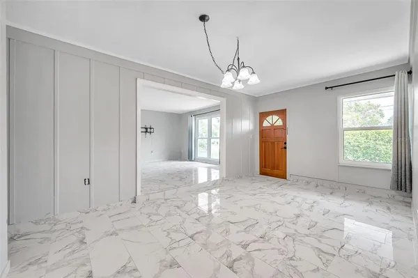 a view of a big room with windows and closet