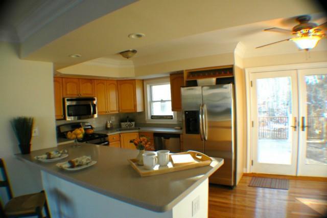 a kitchen with sink refrigerator and large window