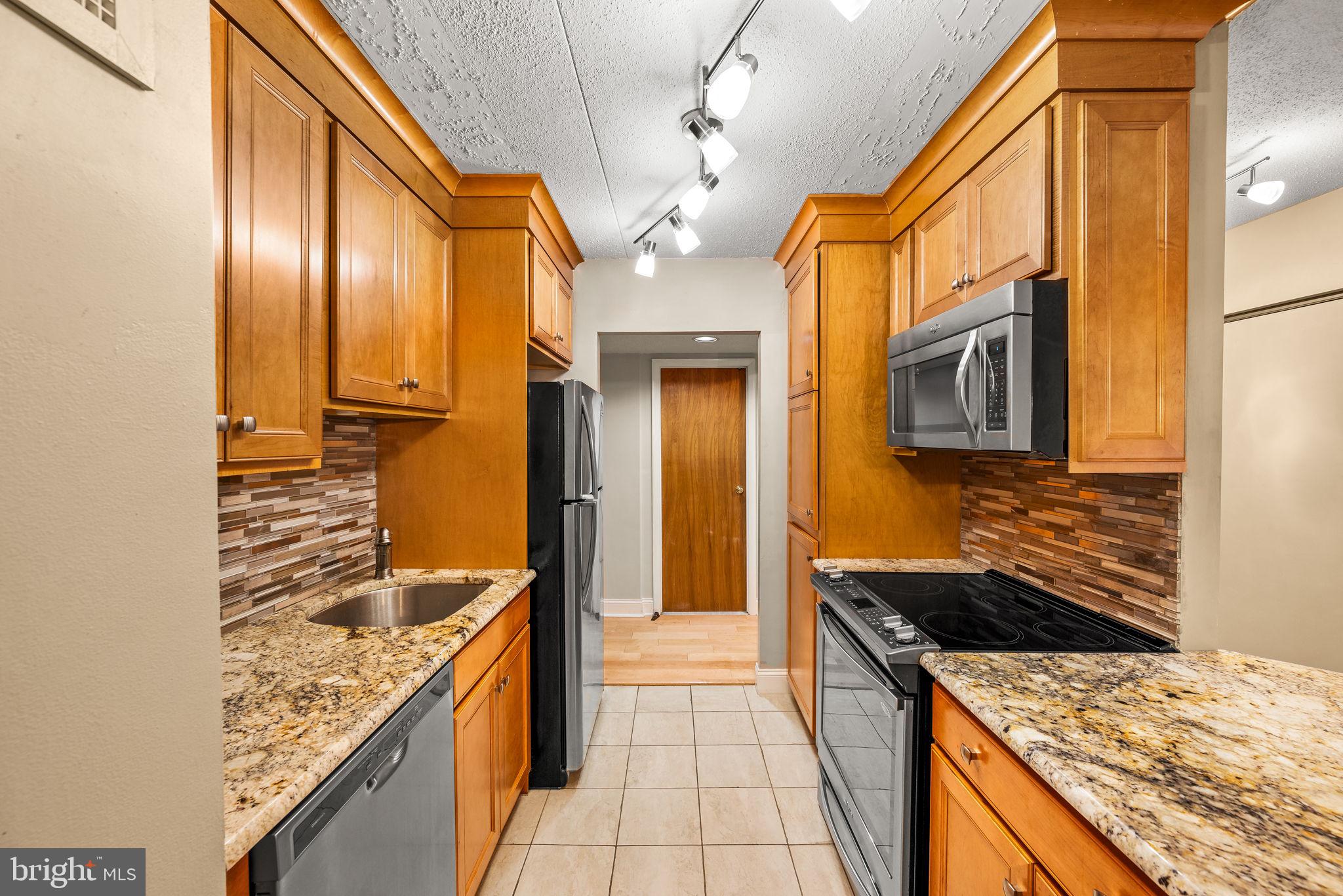 700 Avondale Road, Unit 3D Wallingford, PA 19086 - Photo 7 of 24 Renovated kitchen with hardwood cabinets