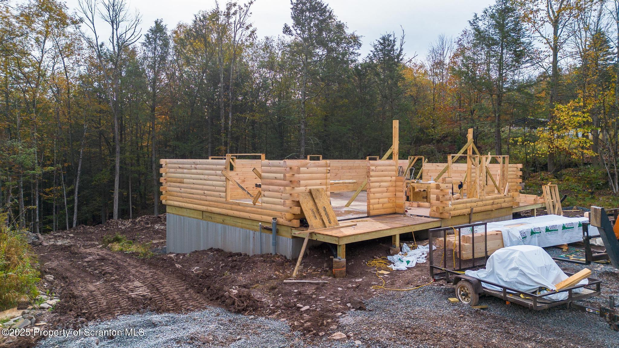 344 Burns Road Waymart, PA 18472 - Photo 14 of 19 a wooden bench sitting in the middle of a forest