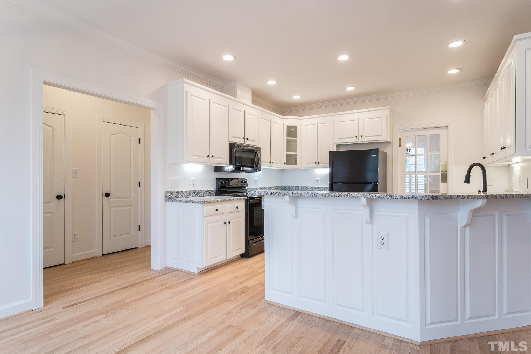 2308 Hideaway Court Raleigh, NC 27613 - Photo 12 of 43 a kitchen with sink a microwave and refrigerator