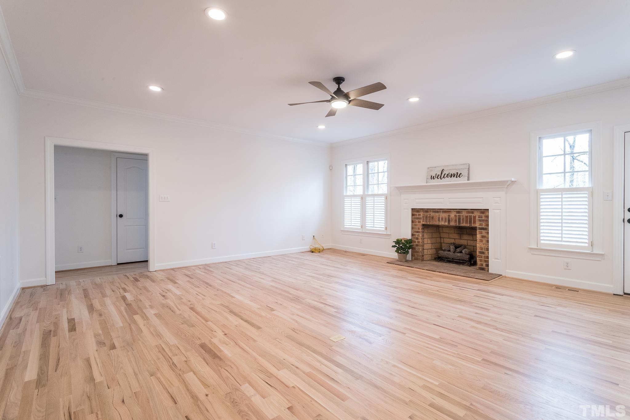 2308 Hideaway Court Raleigh, NC 27613 - Photo 15 of 43 a view of empty room with fireplace and wooden floor