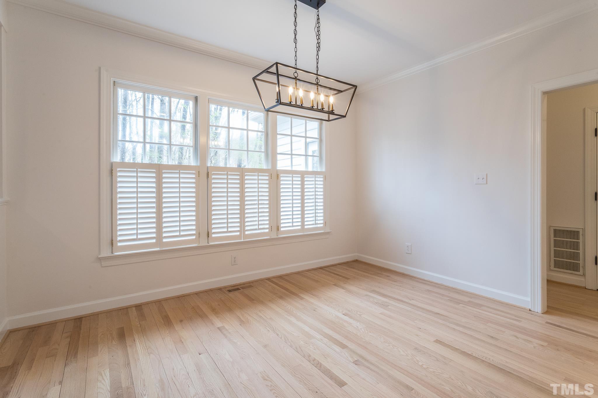 2308 Hideaway Court Raleigh, NC 27613 - Photo 18 of 43 a view of an empty room with wooden floor and a window