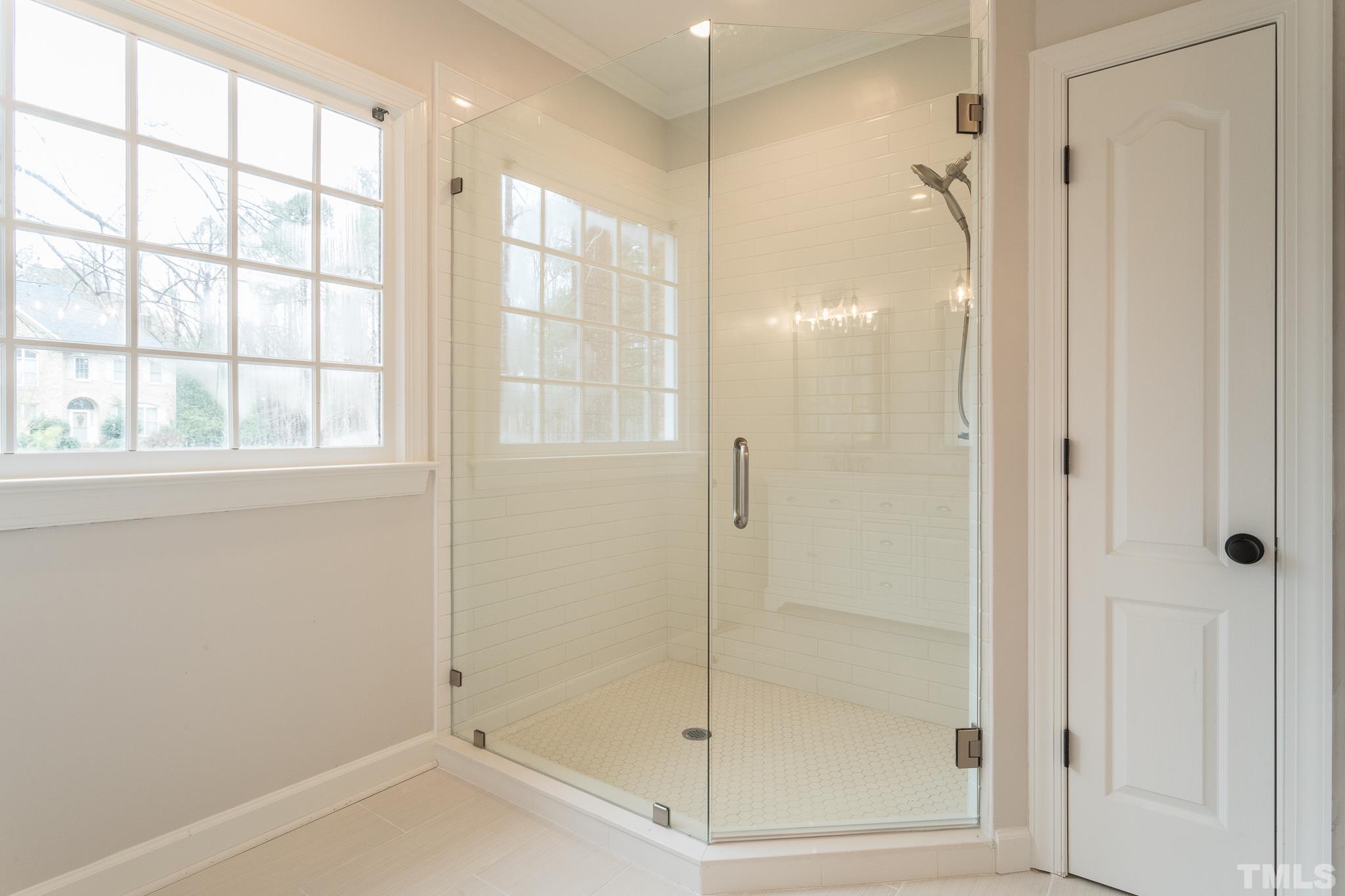 2308 Hideaway Court Raleigh, NC 27613 - Photo 20 of 43 a bathroom with a glass shower door