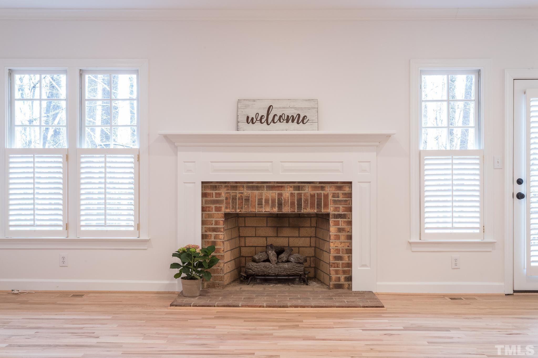 2308 Hideaway Court Raleigh, NC 27613 - Photo 2 of 43 a living room with a fireplace and wooden floor