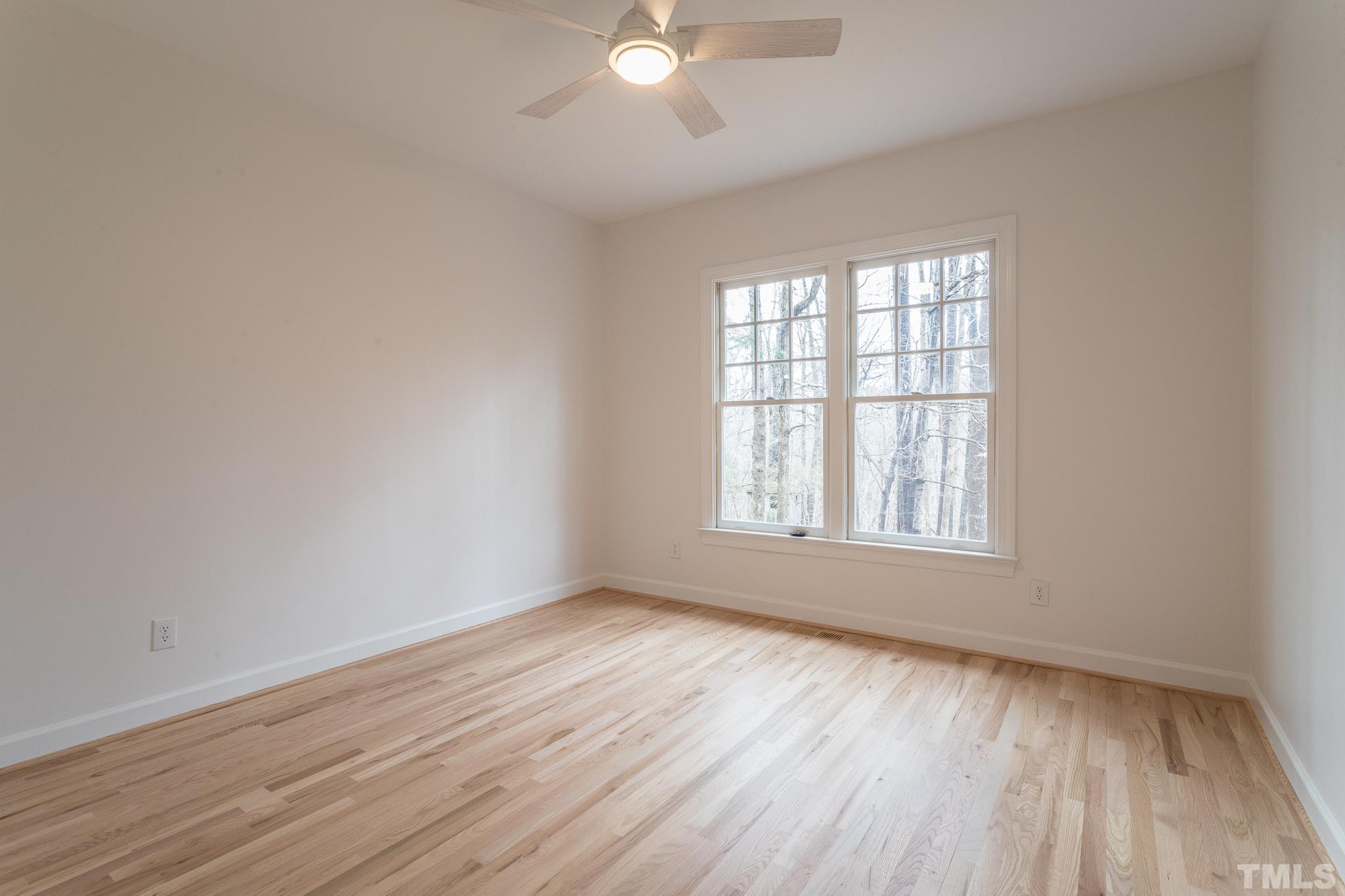 2308 Hideaway Court Raleigh, NC 27613 - Photo 30 of 43 an empty room with wooden floor and windows