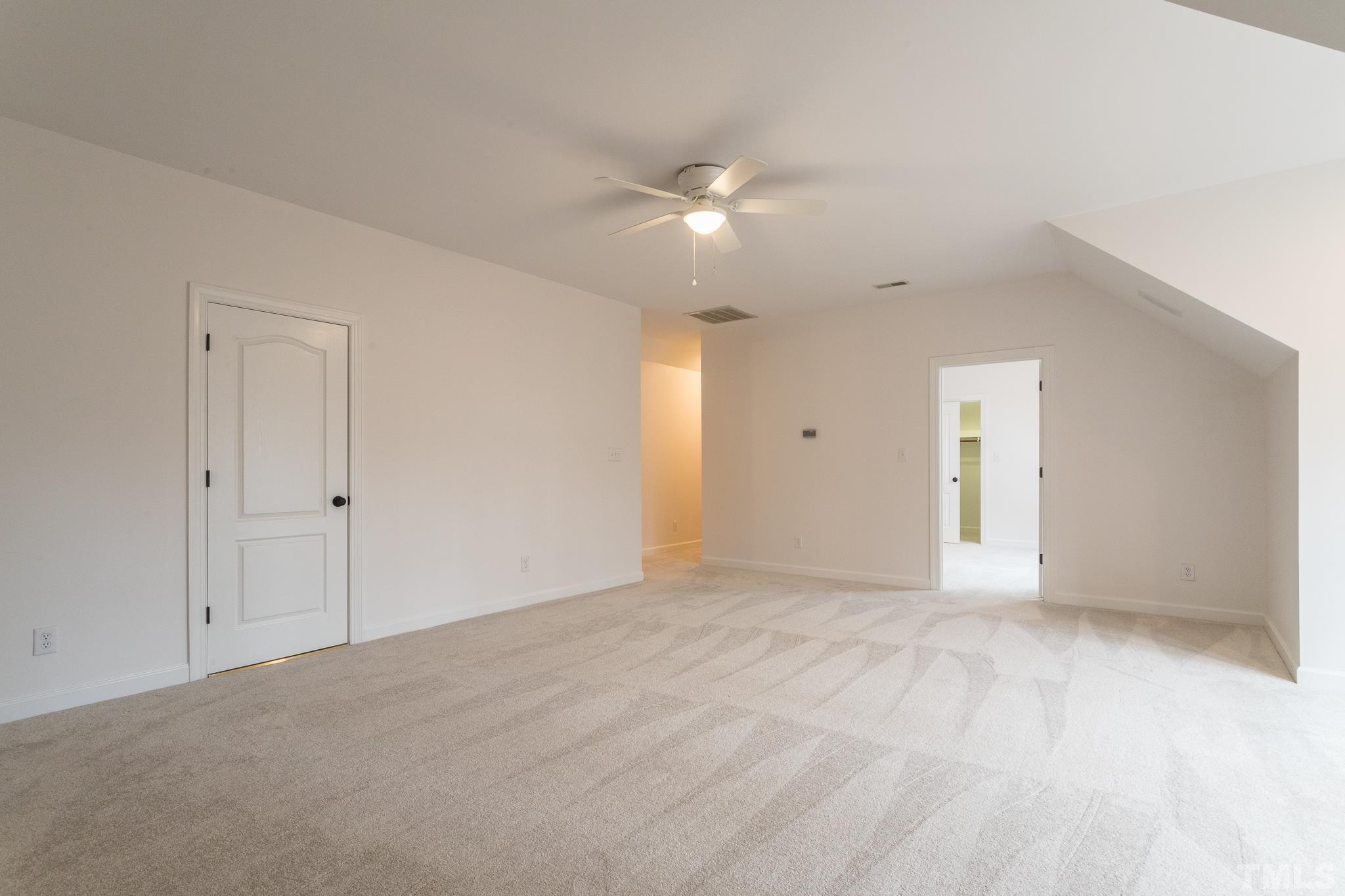 2308 Hideaway Court Raleigh, NC 27613 - Photo 33 of 43 a view of an empty room with a ceiling fan