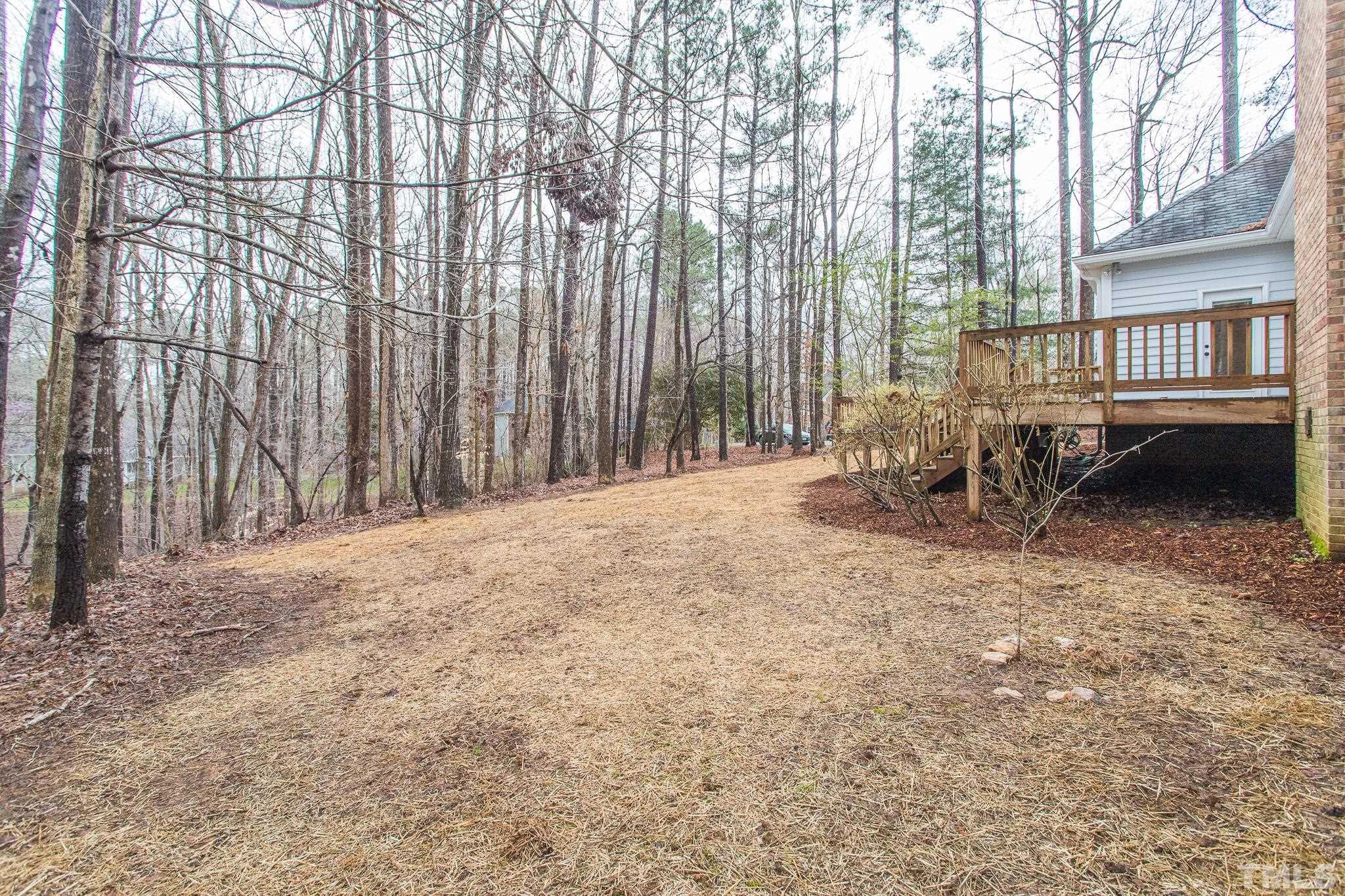 2308 Hideaway Court Raleigh, NC 27613 - Photo 40 of 43 a backyard of a house with table and chairs