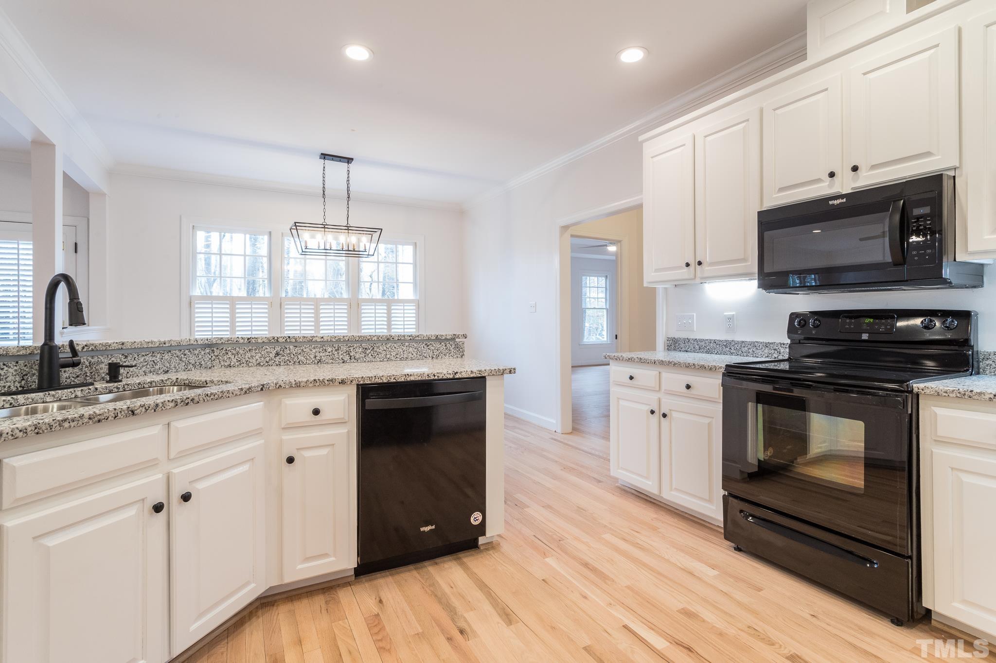 2308 Hideaway Court Raleigh, NC 27613 - Photo 5 of 43 a kitchen with stainless steel appliances granite countertop a stove a sink and a microwave