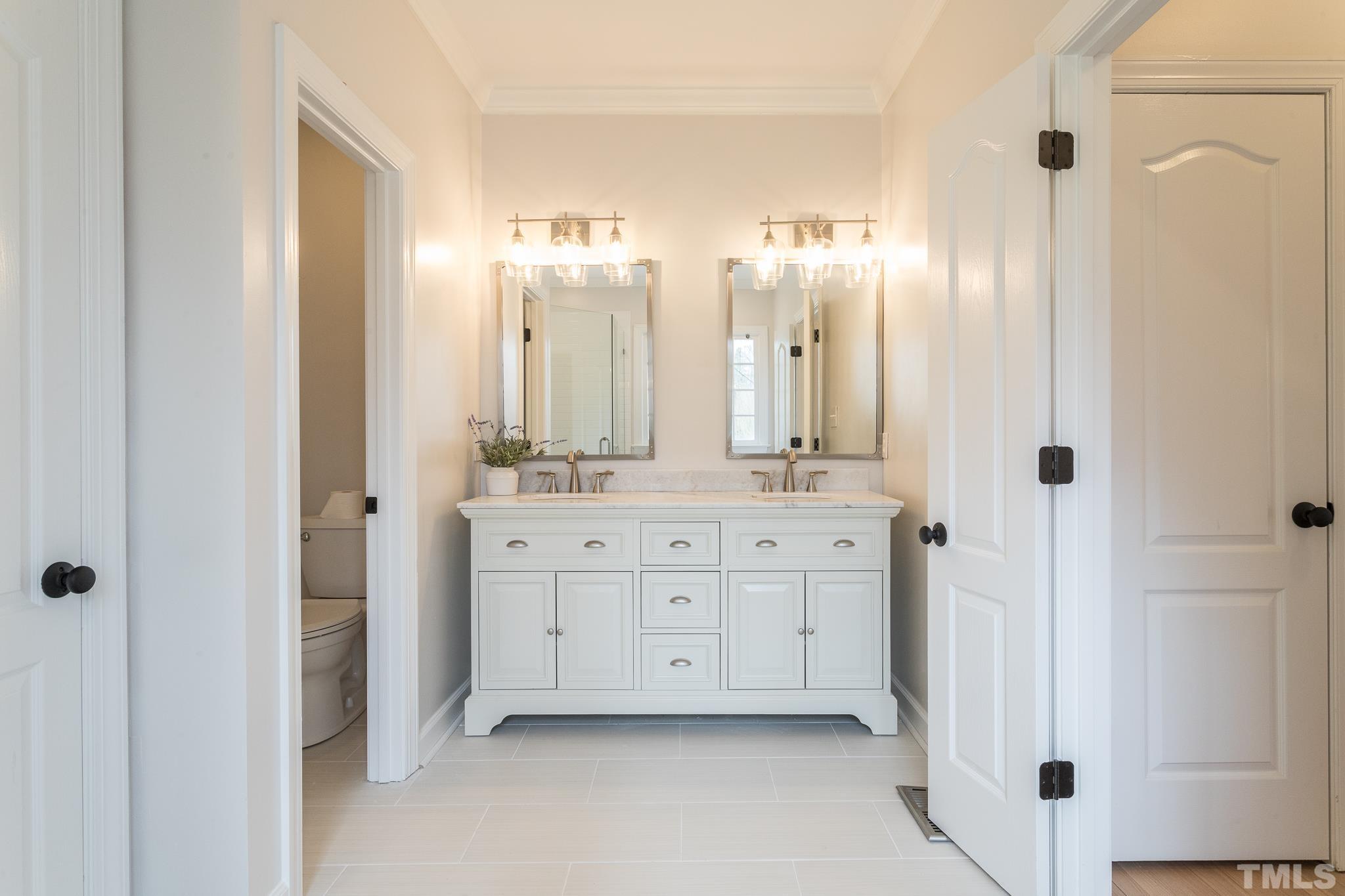 2308 Hideaway Court Raleigh, NC 27613 - Photo 6 of 43 a bathroom with a double vanity sink and mirror