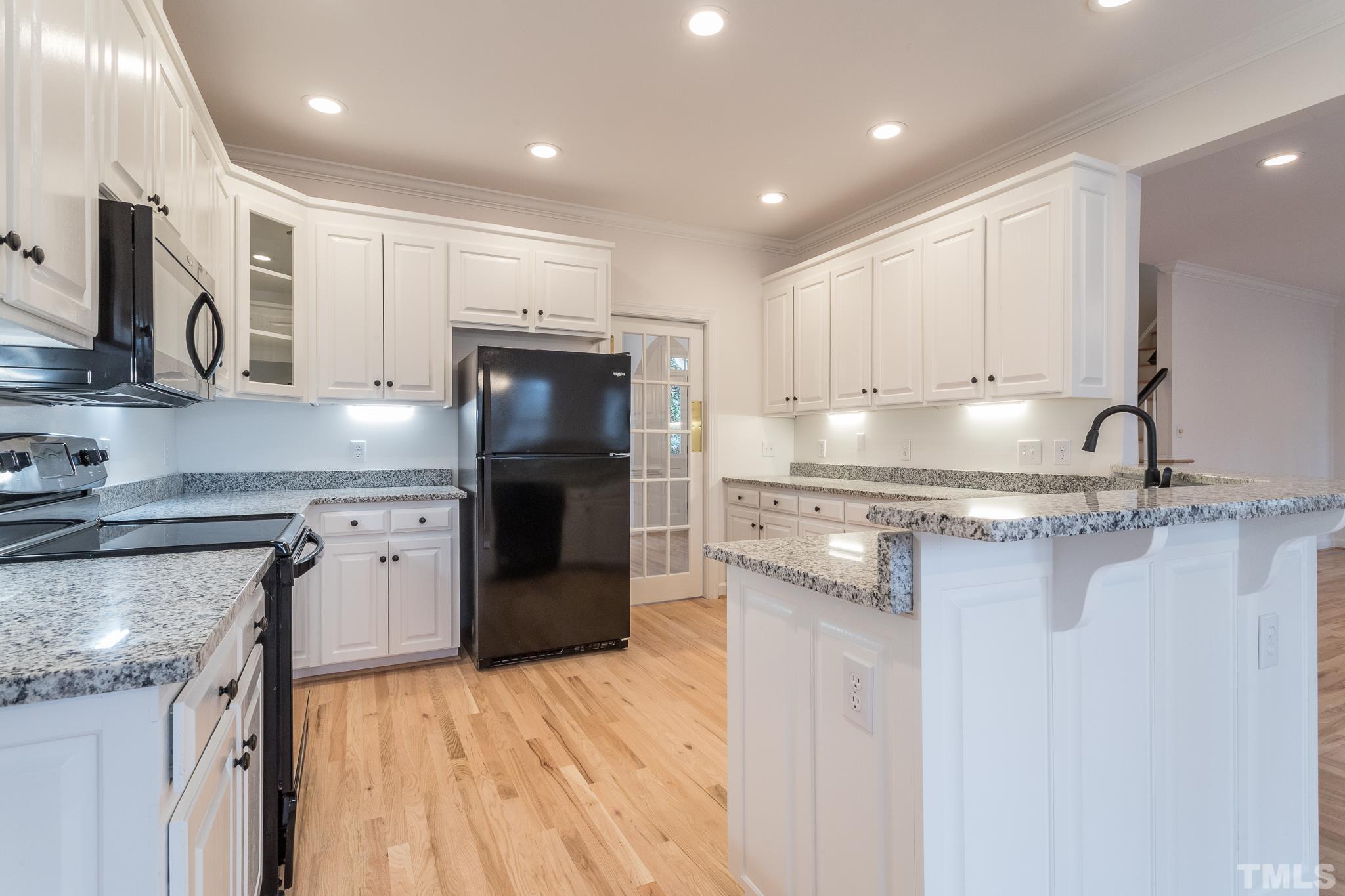 2308 Hideaway Court Raleigh, NC 27613 - Photo 10 of 43 a kitchen with a sink stove and refrigerator
