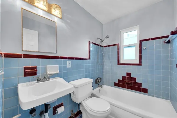 a white toilet sitting next to a bathroom sink