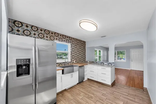 a kitchen with stainless steel appliances granite countertop a refrigerator and stove