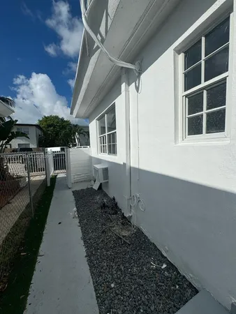 a view of a house with backyard and porch