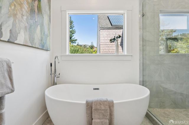 a white bath tub sitting next to a window