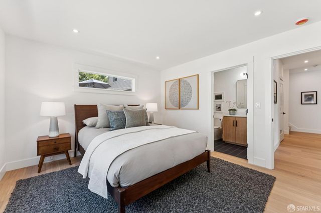 a spacious bedroom with a bed and a couch