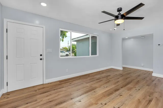 a view of a kitchen with kitchen island a sink stainless steel appliances and cabinets
