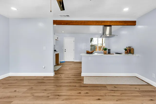 a view of kitchen with stainless steel appliances cabinets and wooden floor
