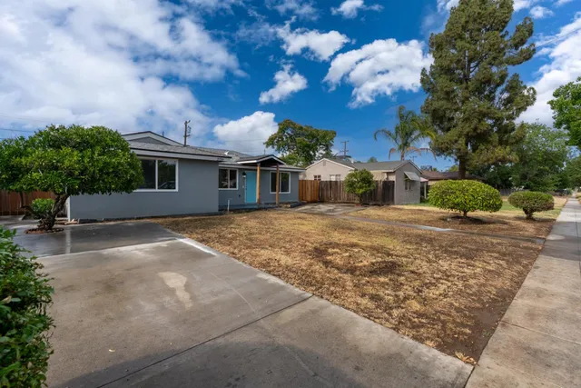a backyard of a house with table and chairs