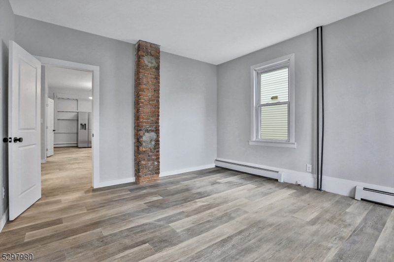 25 Kiel Avenue, Unit 1 Butler, NJ 07405 - Photo 16 of 23 wooden floor in an empty room with a window