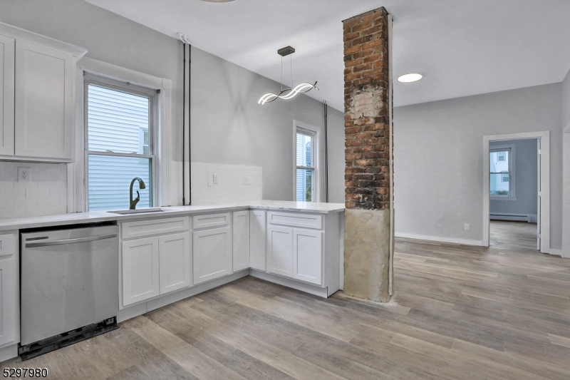 25 Kiel Avenue, Unit 1 Butler, NJ 07405 - Photo 9 of 23 a bathroom with a sink and a mirror