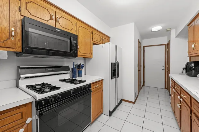 a kitchen with stainless steel appliances granite countertop a stove a refrigerator and a microwave