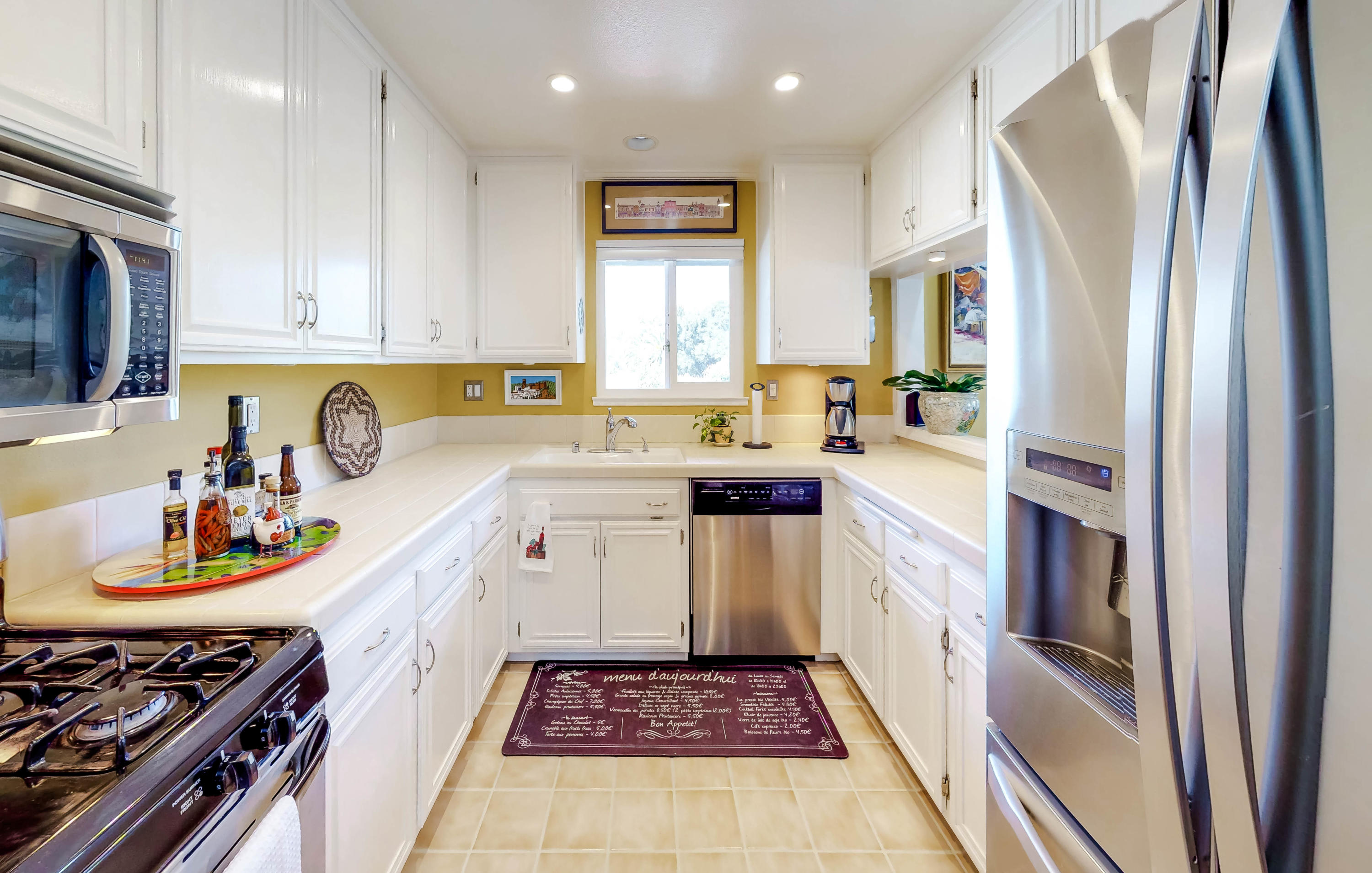 4344 Modoc Road, Unit 16 Santa Barbara, CA 93110 - Photo 5 of 11 a kitchen with a sink stove and cabinets