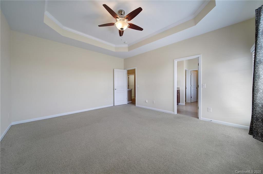 112 Falling Ridge Belmont, NC 28012 - Photo 22 of 30 an empty room with closet and a ceiling fan