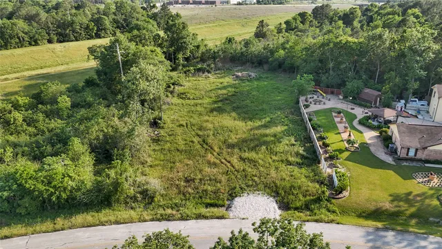 an aerial view of residential house with outdoor space and trees around