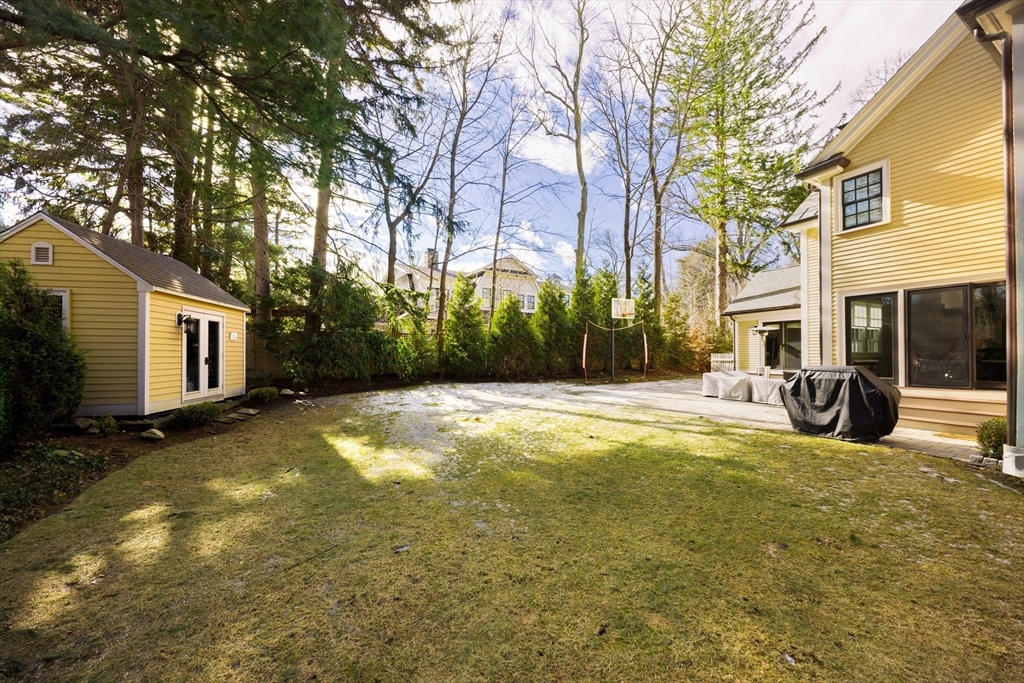 225 Arnold Road Newton, MA 02459 - Photo 17 of 20 a view of a house with a large tree and a yard