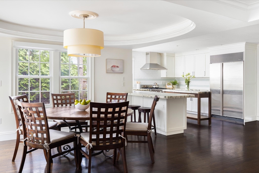 225 Arnold Road Newton, MA 02459 - Photo 8 of 20 a dining room with furniture a chandelier and wooden floor