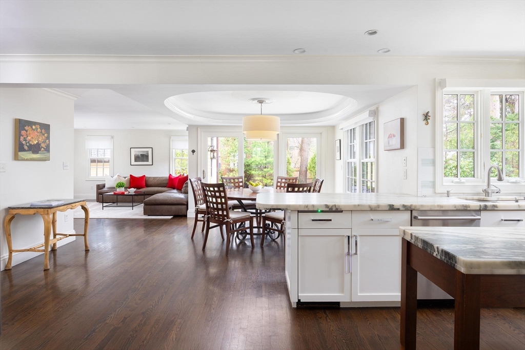 225 Arnold Road Newton, MA 02459 - Photo 9 of 20 a open kitchen with stainless steel appliances granite countertop dining table chairs and wooden floor
