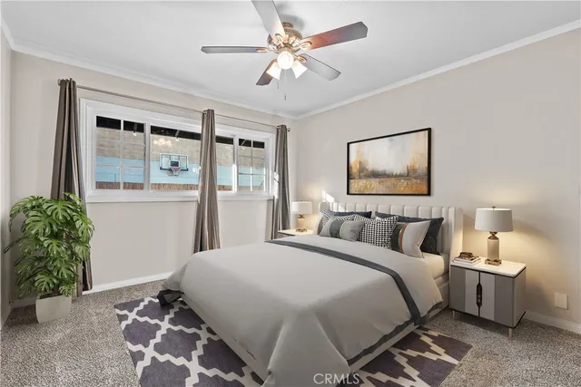 a bedroom with a large bed and a potted plant