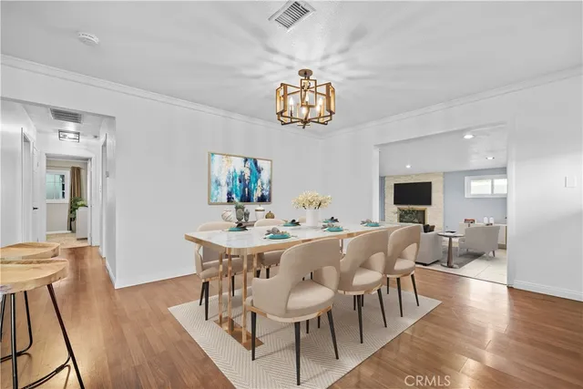 a view of a dining room with furniture wooden floor and chandelier