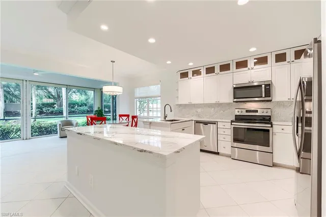a kitchen with stainless steel appliances granite countertop a stove and a refrigerator