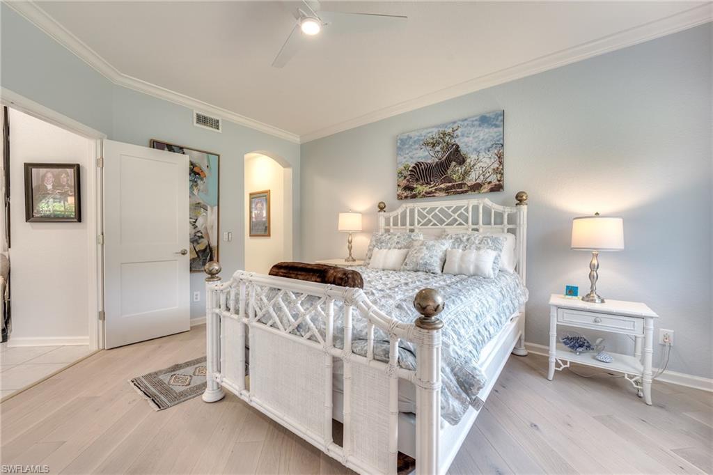 23136 Rosedale Drive, Unit 102 Estero, FL 34135 - Photo 18 of 32 a bedroom with a bed and a table