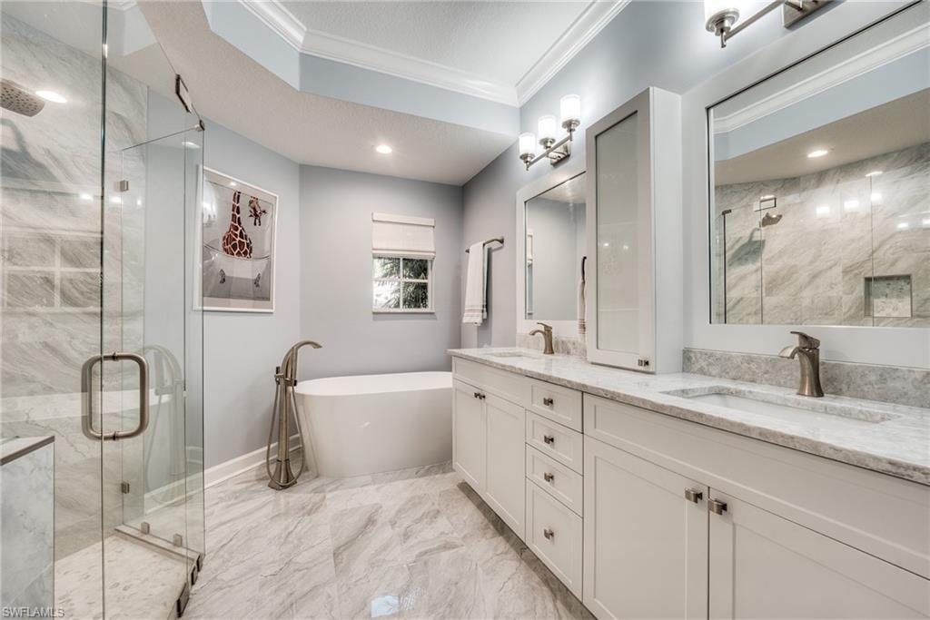 23136 Rosedale Drive, Unit 102 Estero, FL 34135 - Photo 24 of 32 a bathroom with a granite countertop sink mirror and toilet