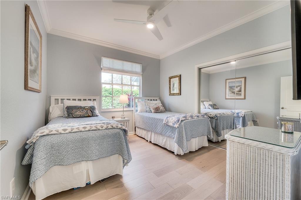 23136 Rosedale Drive, Unit 102 Estero, FL 34135 - Photo 29 of 32 a bedroom with a bed and a couch