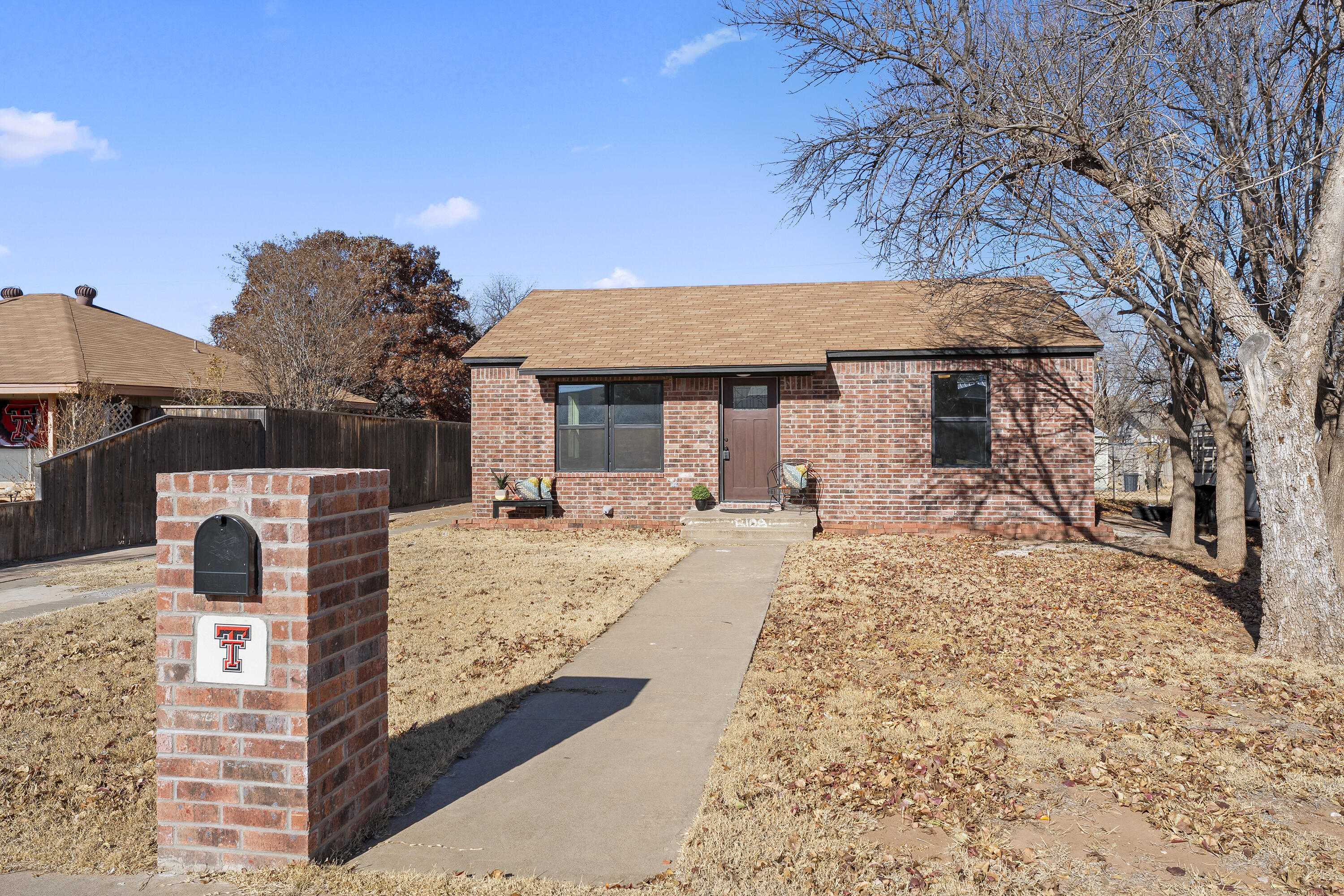 a view of a backyard with a patio and fire pit