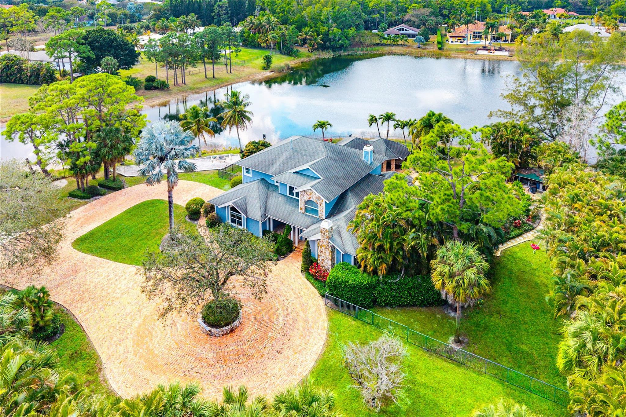 8035 Dillman Road West Palm Beach, FL 33411 - Photo 1 of 70 an aerial view of a house with a lake view