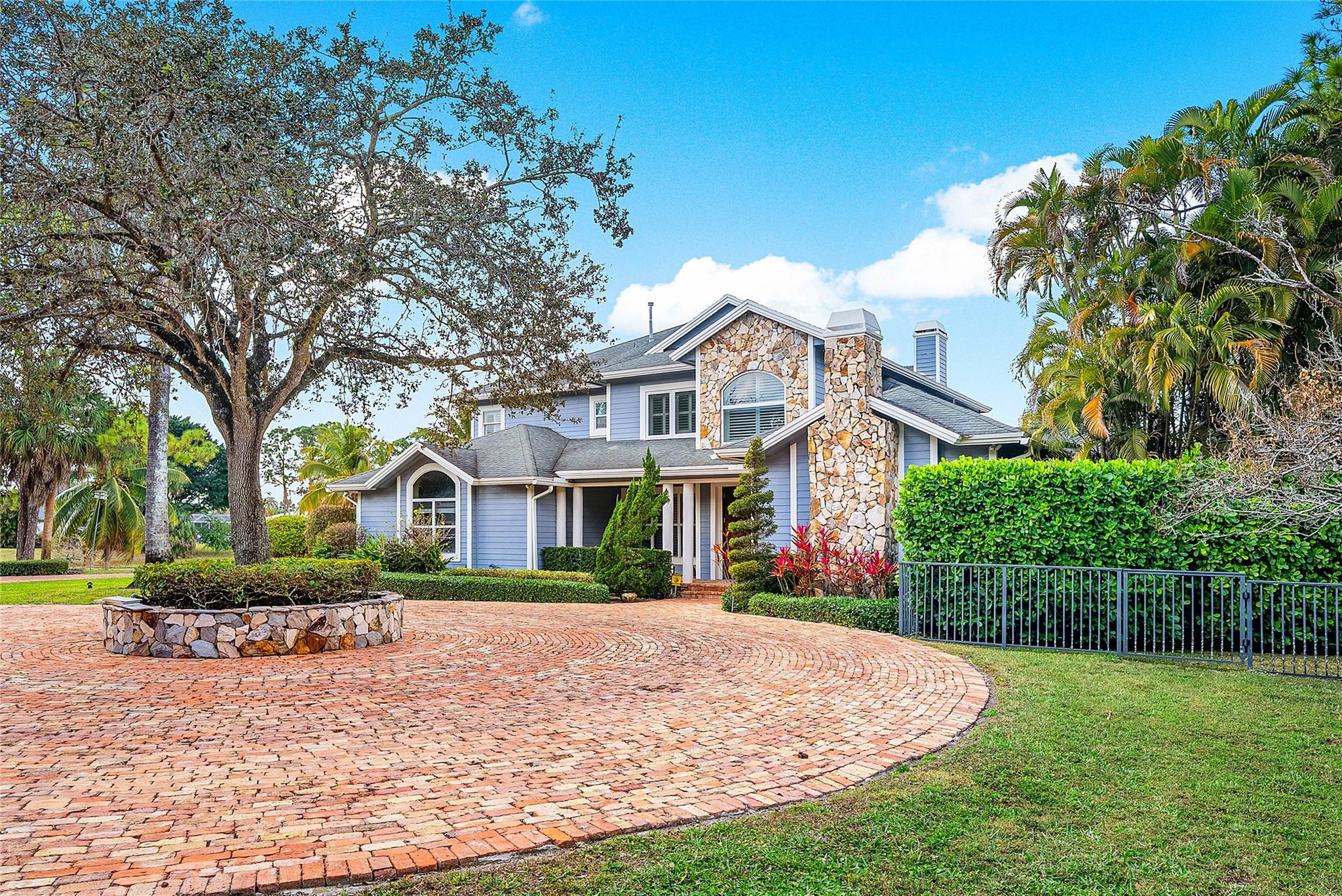 8035 Dillman Road West Palm Beach, FL 33411 - Photo 12 of 70 a front view of a house with a garden
