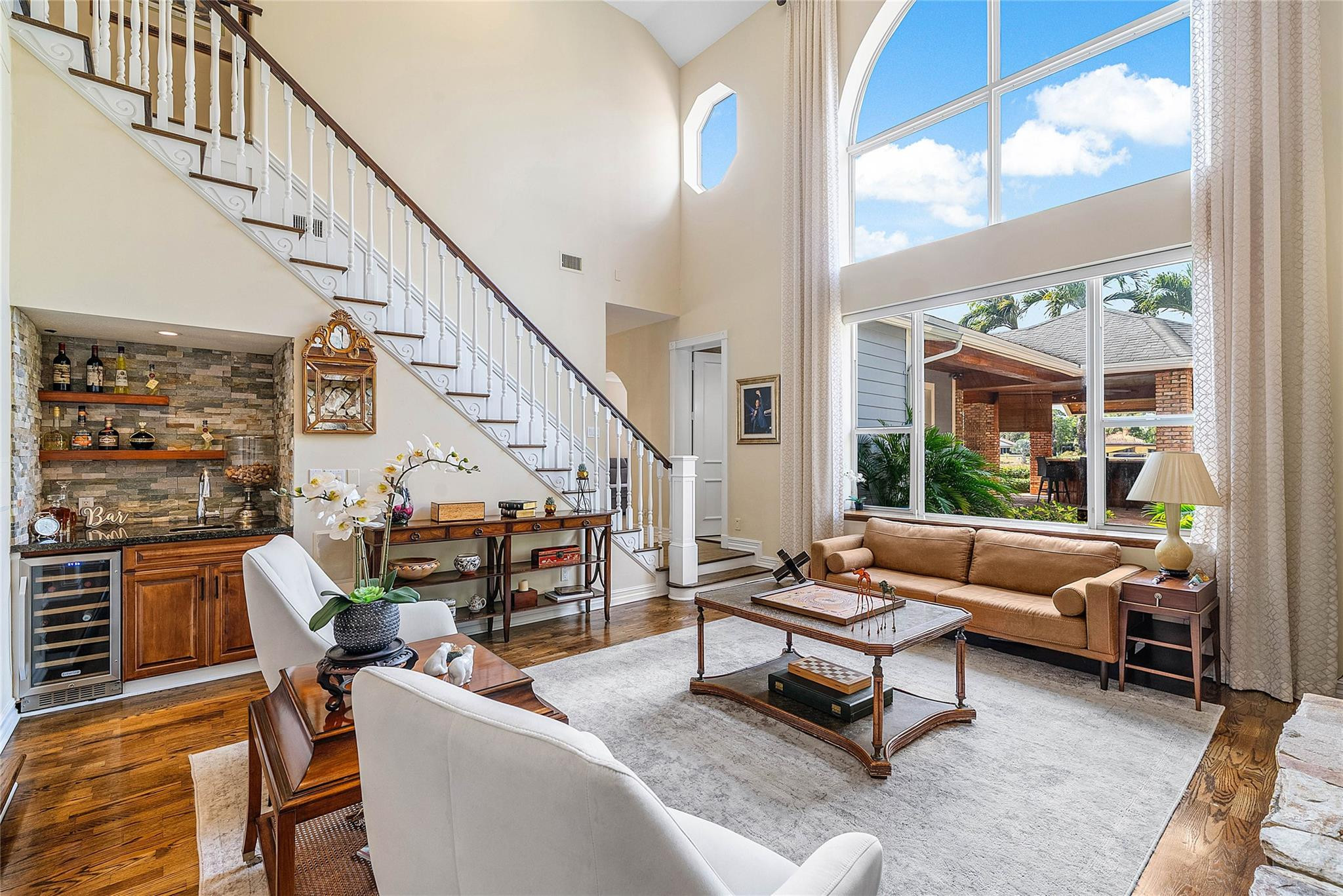 8035 Dillman Road West Palm Beach, FL 33411 - Photo 16 of 70 a living room with furniture a fireplace and a large window