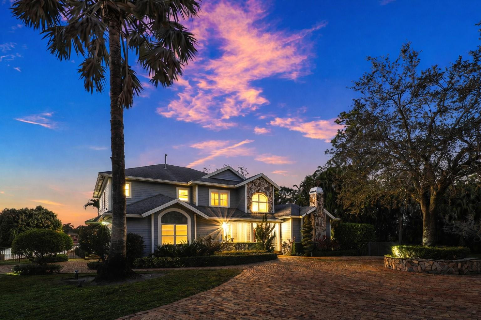 8035 Dillman Road West Palm Beach, FL 33411 - Photo 2 of 70 a front view of a house with a yard and garage