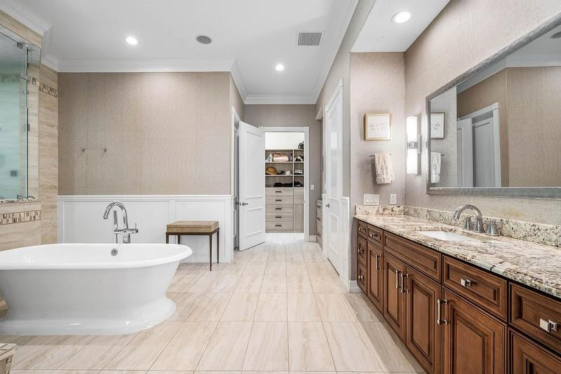 8035 Dillman Road West Palm Beach, FL 33411 - Photo 28 of 70 a bathroom with a double vanity sink and a mirror