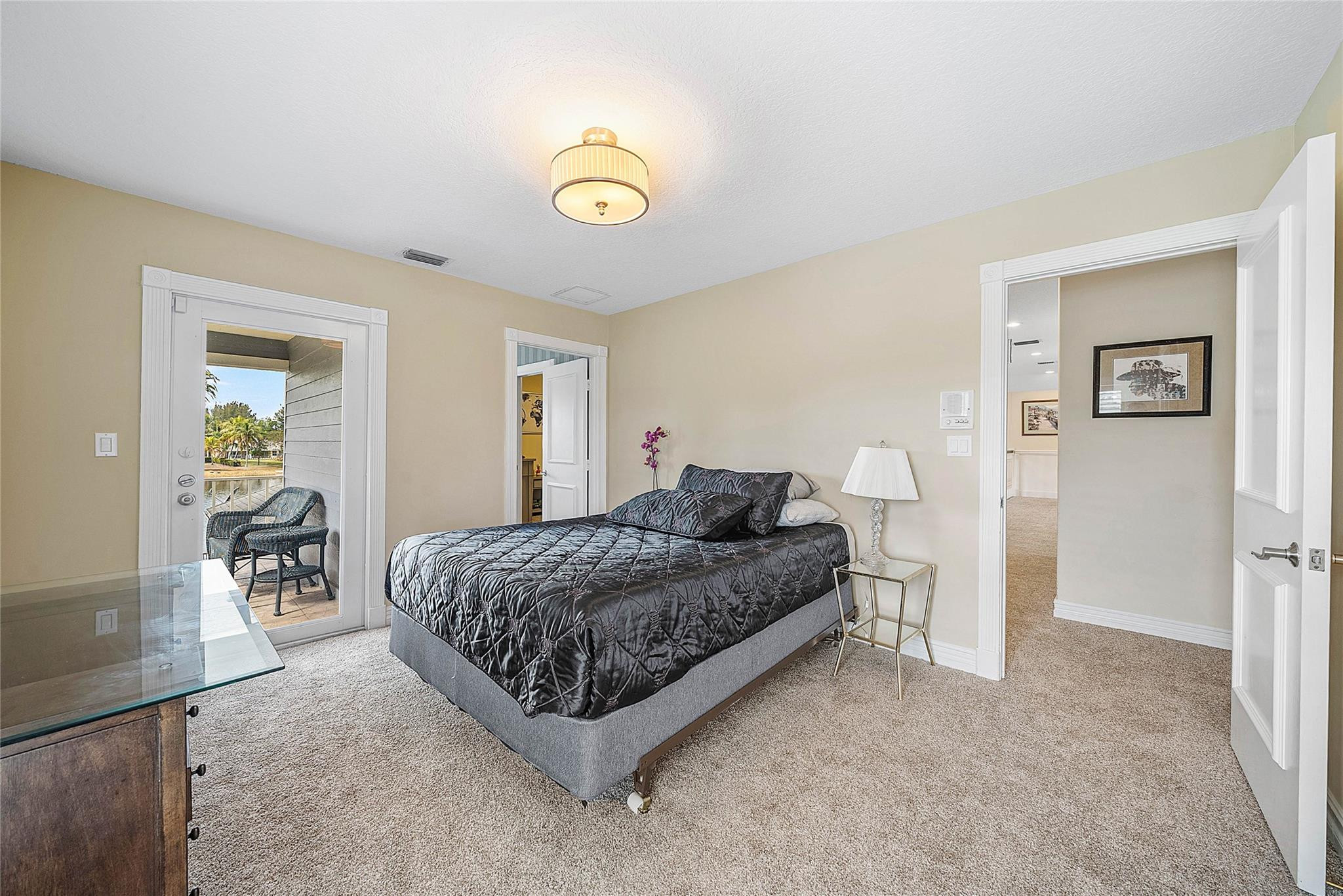 8035 Dillman Road West Palm Beach, FL 33411 - Photo 38 of 70 a spacious bedroom with a bed and table